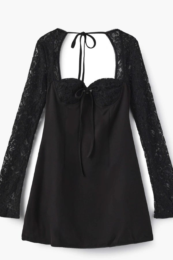 A black mini dress with delicate lace details, designed with a flattering, figure-enhancing fit. It features a tie at the back and long sleeves with lace accents.