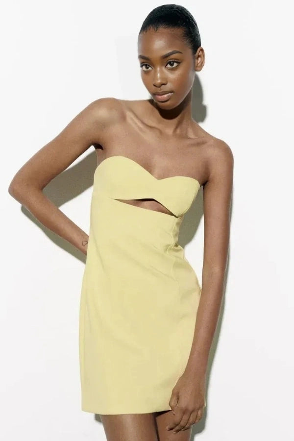 Model wearing the Kouvr Fashion yellow strapless cutout mini dress from the front