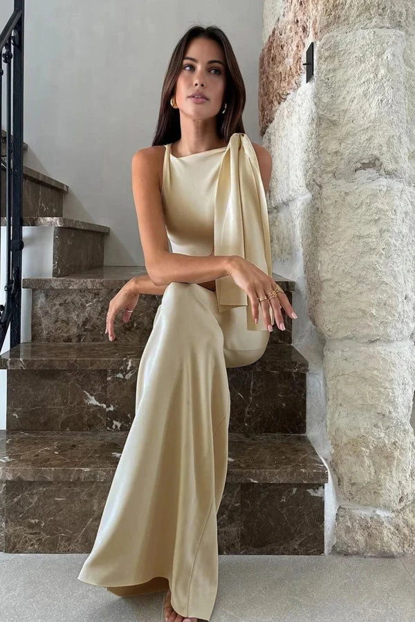 Model wearing the Kouvr Fashion Athena one shoulder satin gown in champagne ivory on a marble staircase