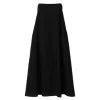 Model wearing Kouvr Fashion black linen maxi dress with white tie-back straps