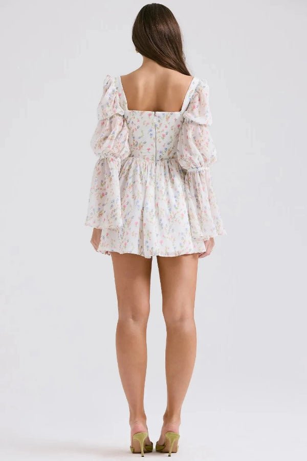 Model wearing the Kouvr Fashion white floral puff sleeve mini dress