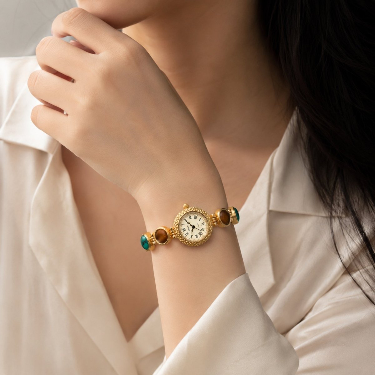 Detailed macro shot of the watch's adjustable gold-tone stainless steel jewelry clasp, demonstrating the secure closure mechanism and seamless stone link integration.