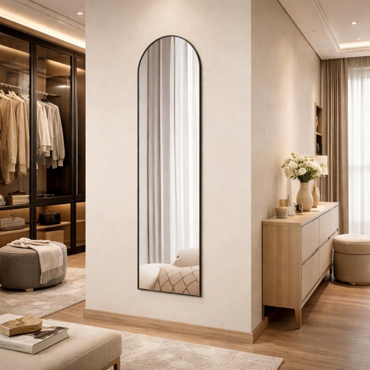 Sleek black arched full length floor mirror standing in a modern luxury walk-in closet with ambient lighting.
