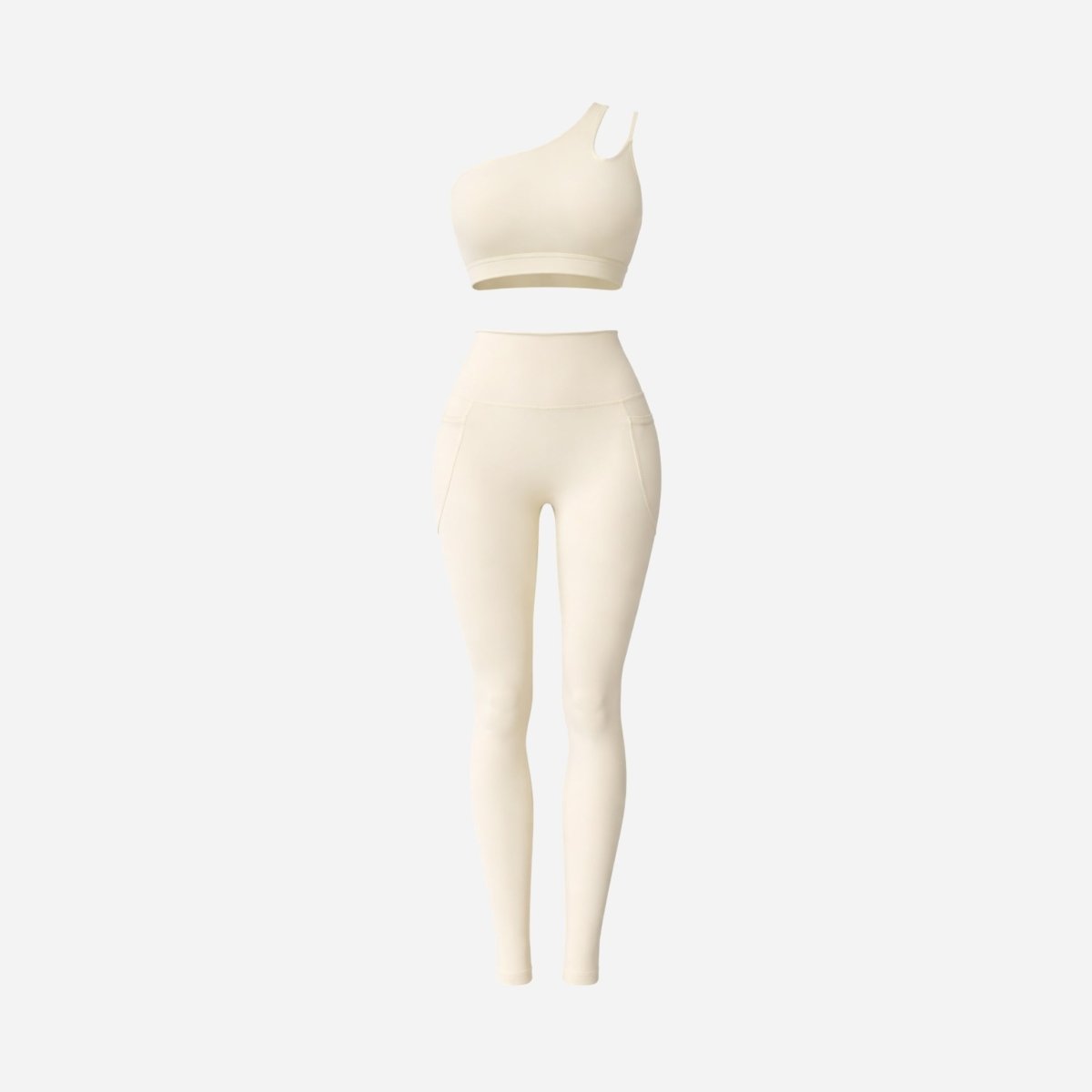 Studio flatlay of Kouvr two piece cream activewear outfit featuring one shoulder top and pocket leggings against a white background.