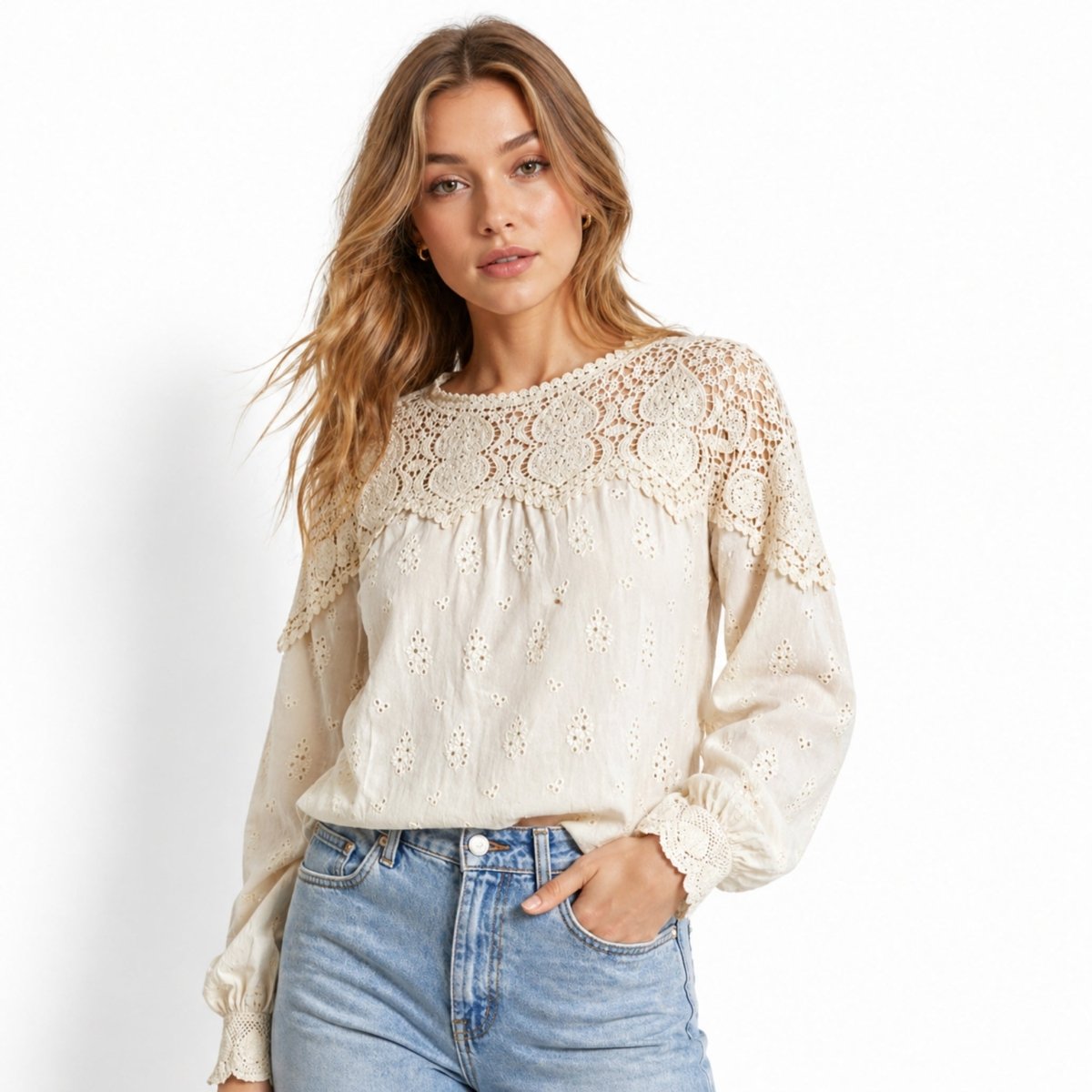 Close up shot of affordable luxury beige broderie anglaise shirt with hand in pocket styling over vintage denim