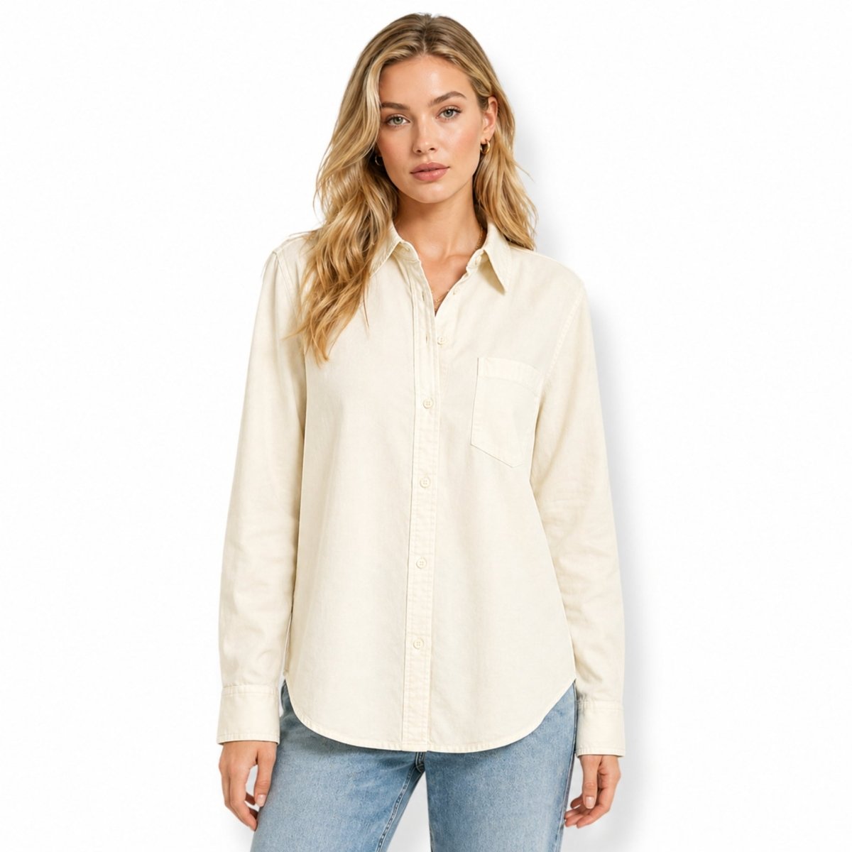 Woman wearing a premium beige heavyweight cotton button-down shirt in a relaxed fit, paired with light blue jeans.