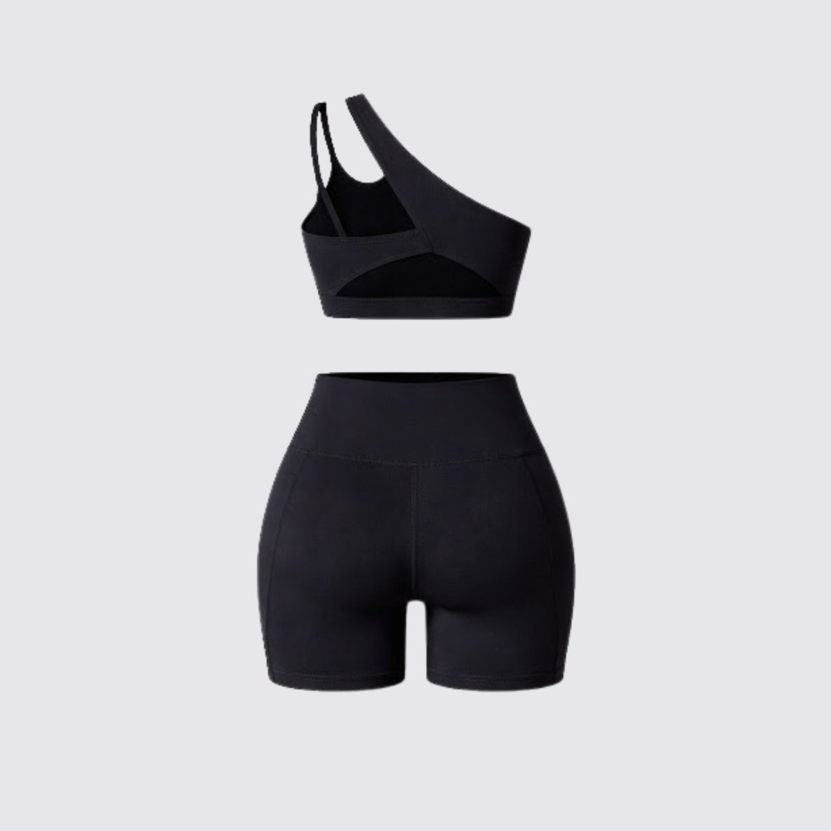 Flat lay back view of Kouvr black matching workout set showing sports bra back strap details and biker shorts construction