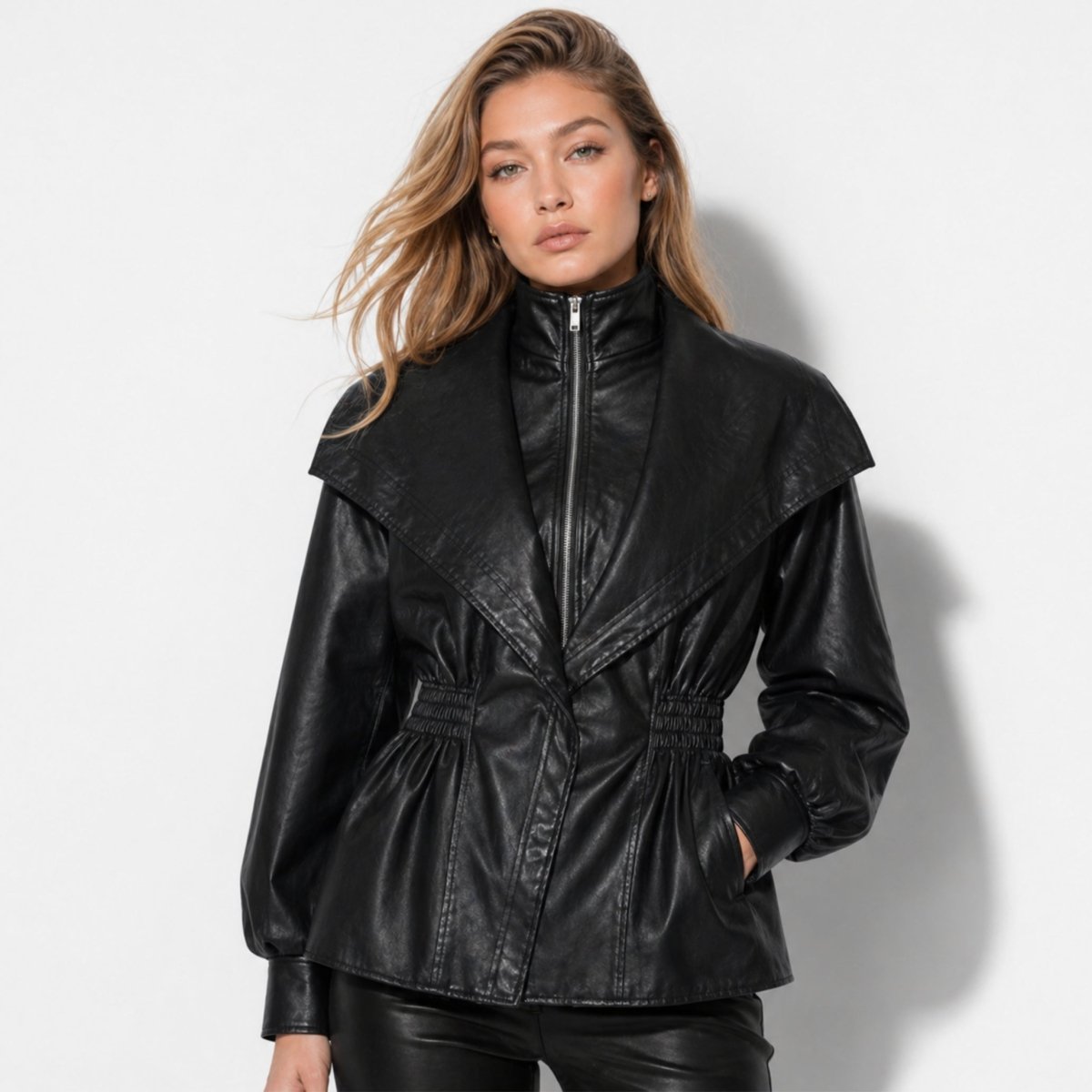 Woman wearing Kouvr black faux leather peplum jacket with oversized collar and cinched waist facing forward.