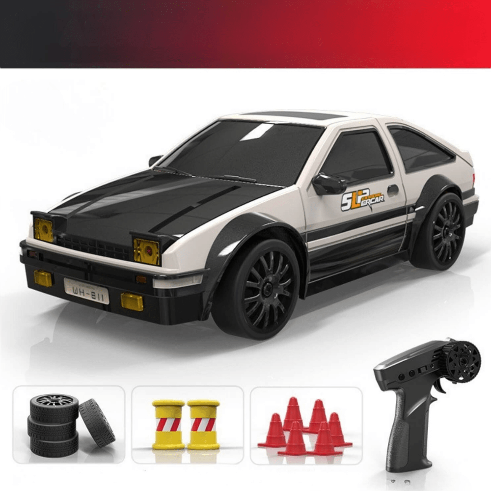 Black muscle car style RC drift car with yellow stripes, shown with its remote, battery, charger, water dropper, and spare tires.