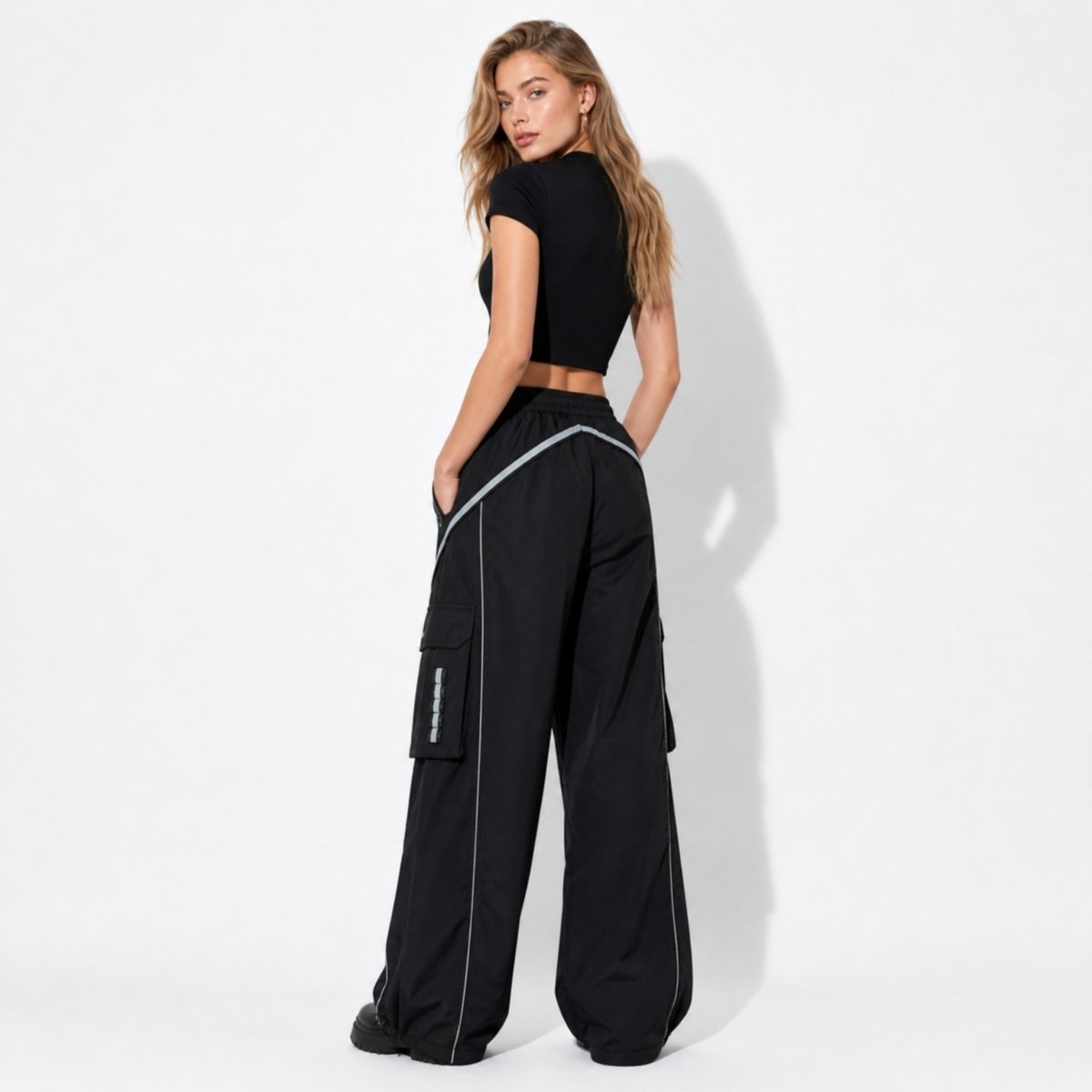 Back view of women's relaxed fit black wide leg trousers featuring a comfortable elastic gathered waistband