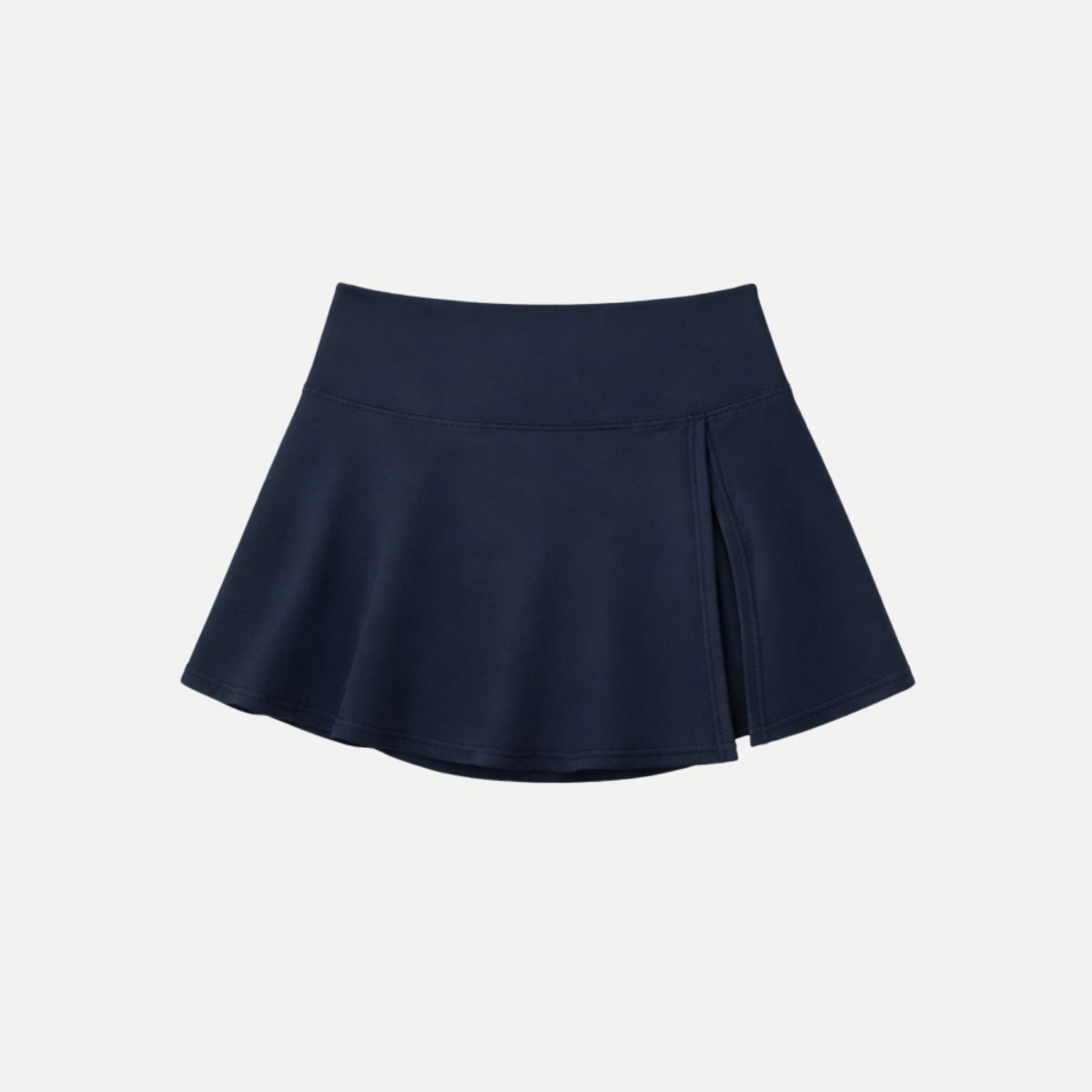 Flat lay product shot of Kouvr blue high-waisted tennis skort featuring wide waistband and asymmetrical front slit.