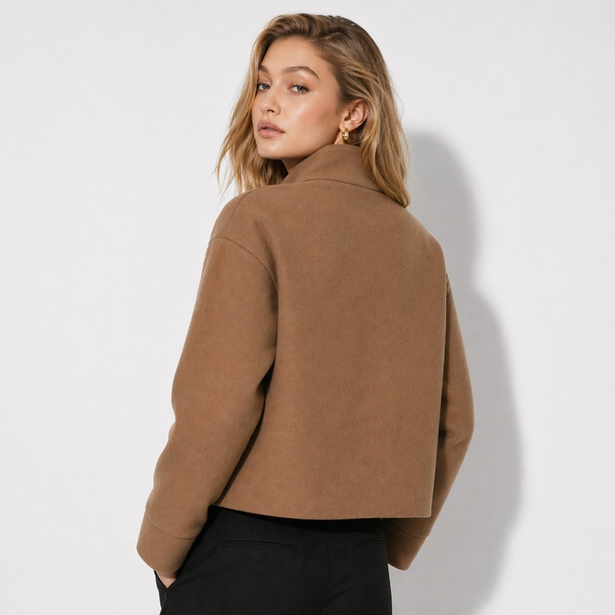 Back view of women's minimalist brown cropped outerwear showing structured relaxed fit.