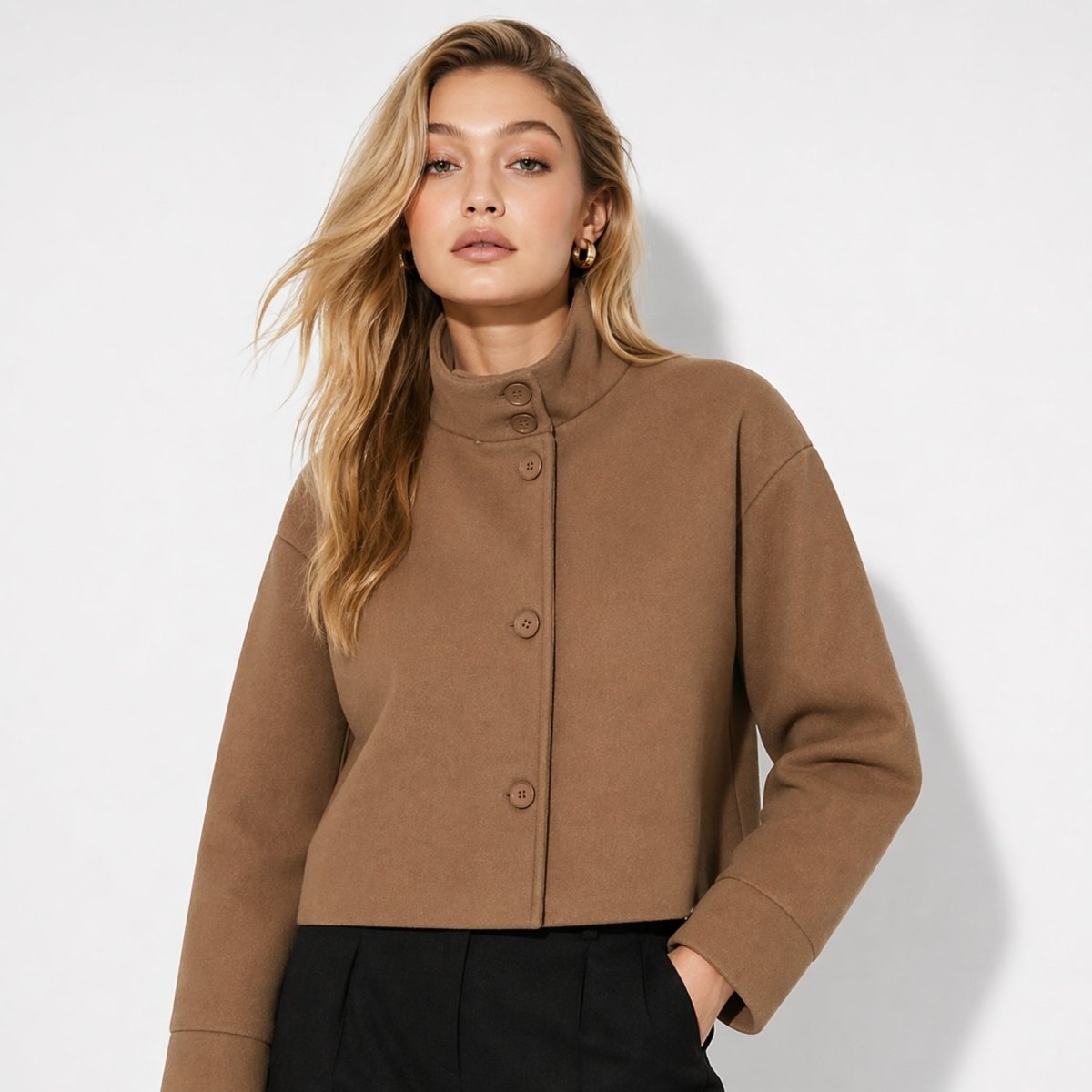 Woman wearing Kouvr brown wool blend cropped funnel neck jacket with black trousers looking elegant.