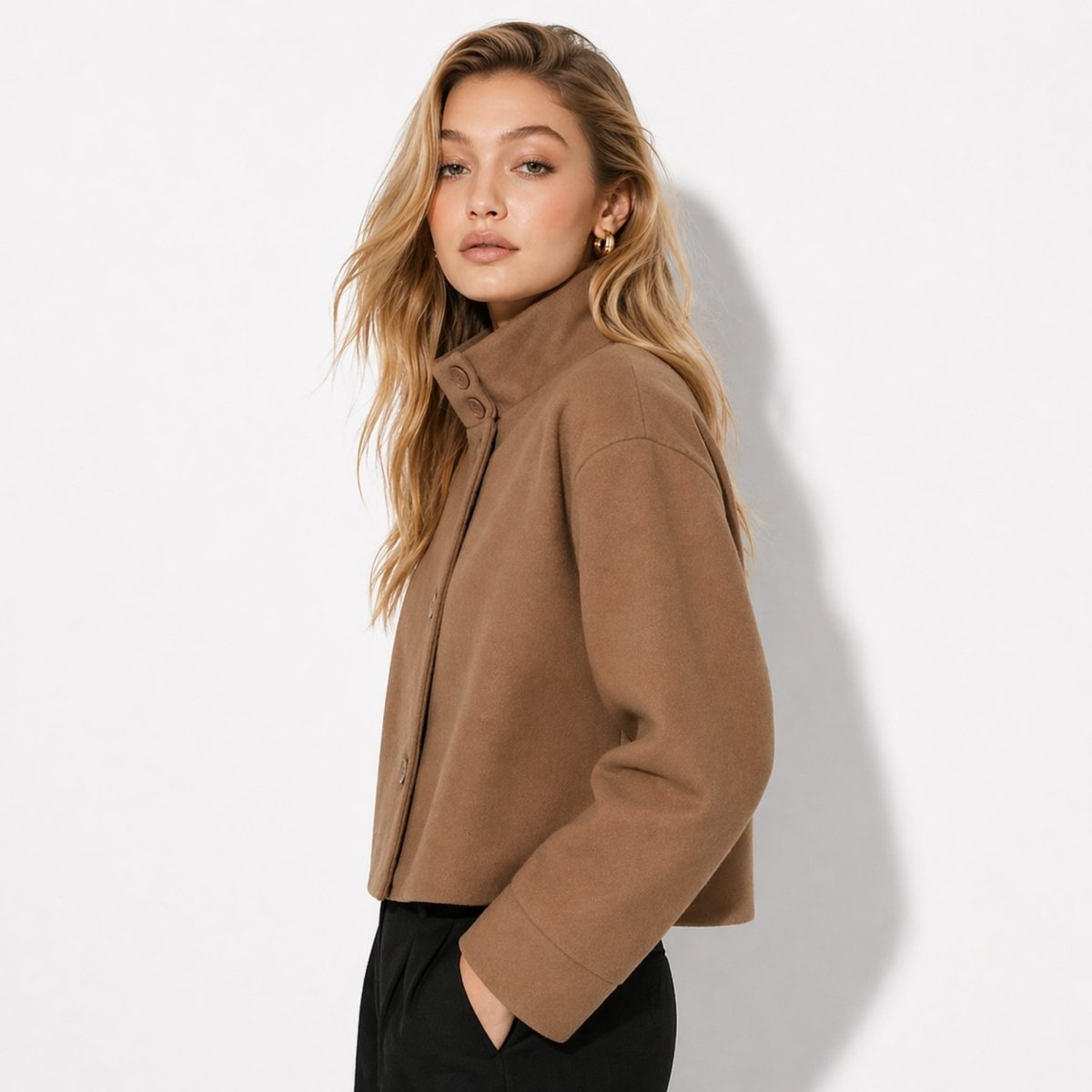 Side profile of Kouvr boxy short brown winter coat highlighting drop shoulder and wide sleeves.