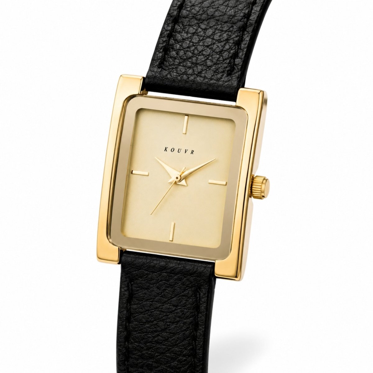 Angled close-up of the Kouvr watch showing the minimalist gold dial, delicate hands, and scratch-resistant crystal glass face.