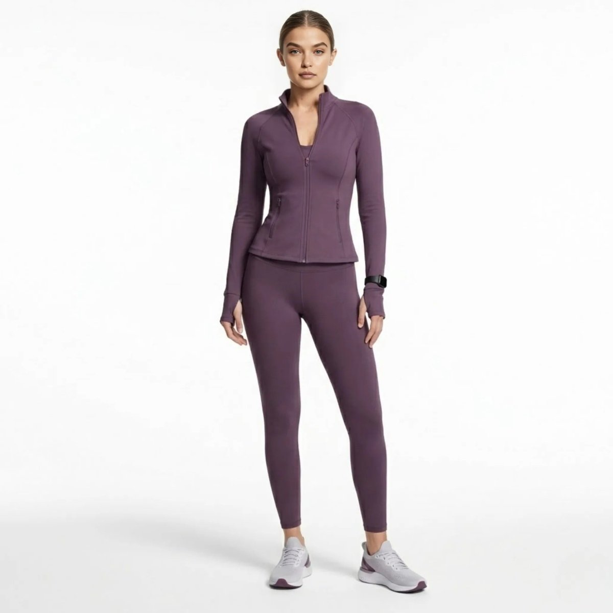 Full body view of woman modeling Kouvr deep plum activewear jacket and matching leggings