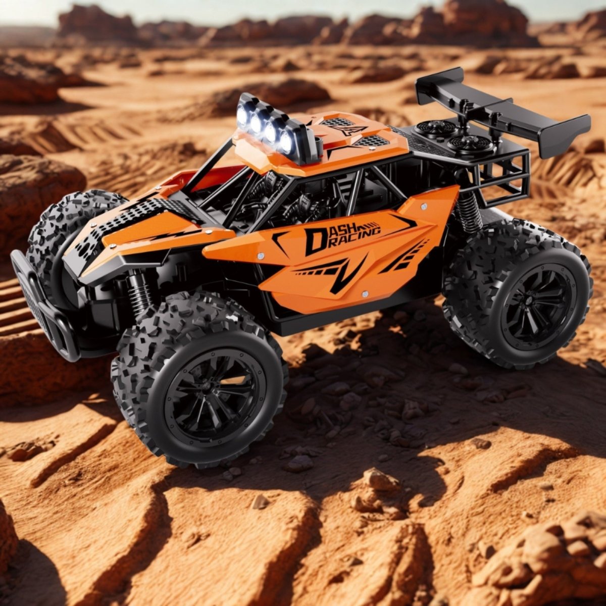 The bright orange Dash Racing high-speed RC truggy with its LED lights on, sitting amongst rocks in a desert landscape.