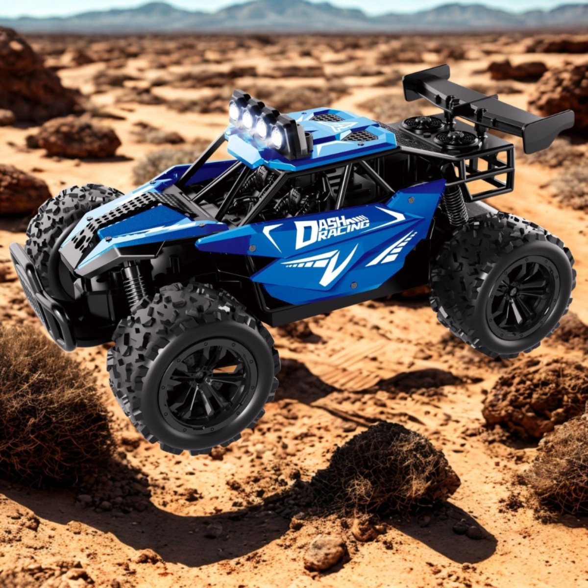 The blue Dash Racing off-road RC buggy captured mid-air as it jumps over desert rocks and brush, showcasing its suspension.