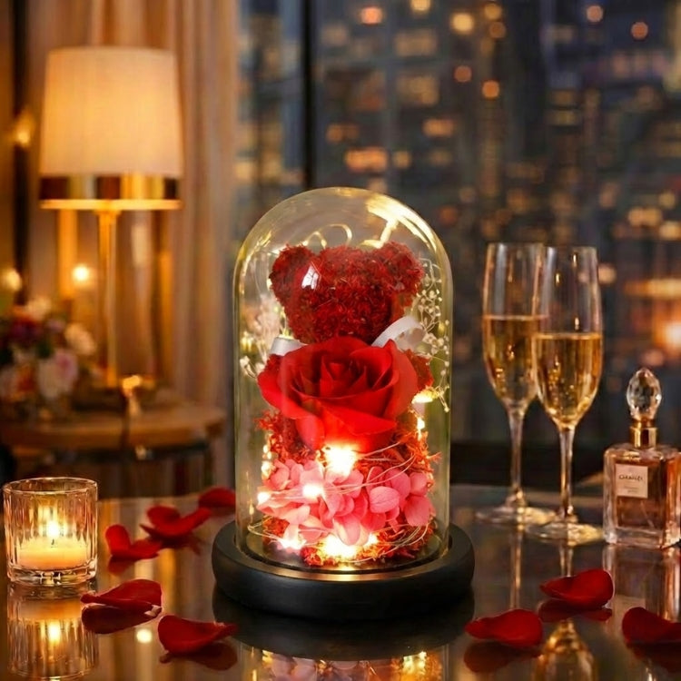 Crimson red eternal flower bear in a light-up glass dome, set on a glass table with romantic candlelight.