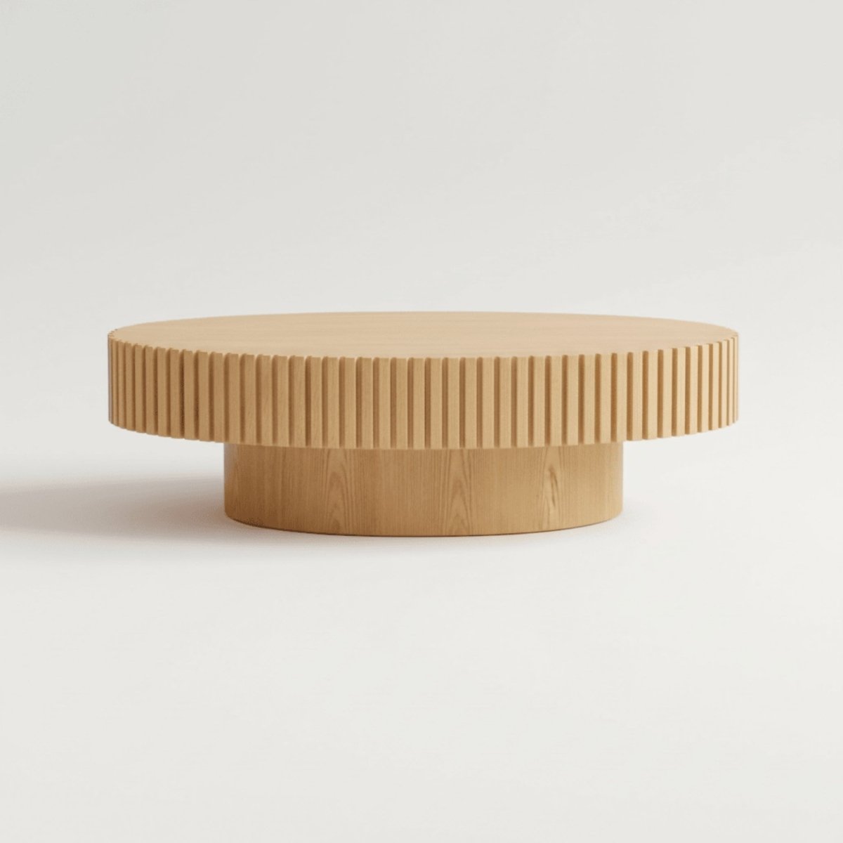Studio shot of modern fluted oval wood coffee table with ribbed detailing against white background.