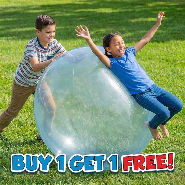 Two smiling children pushing a giant blue inflatable bubble ball across the grass in a backyard, featuring a buy one get one free special.