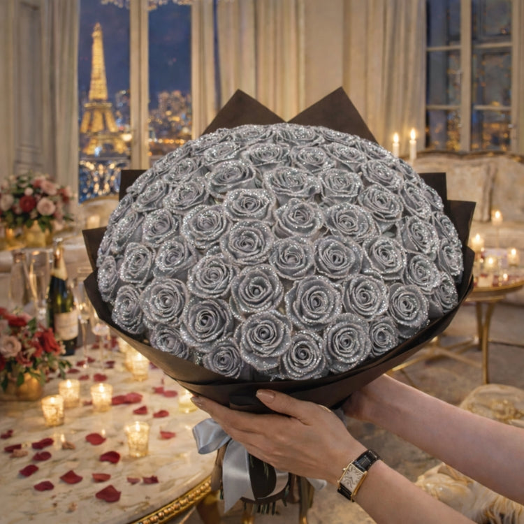 A massive, round bouquet of silver sparkle roses held in a luxury room. Eternal chrome-colored flowers that sparkle under the lights.