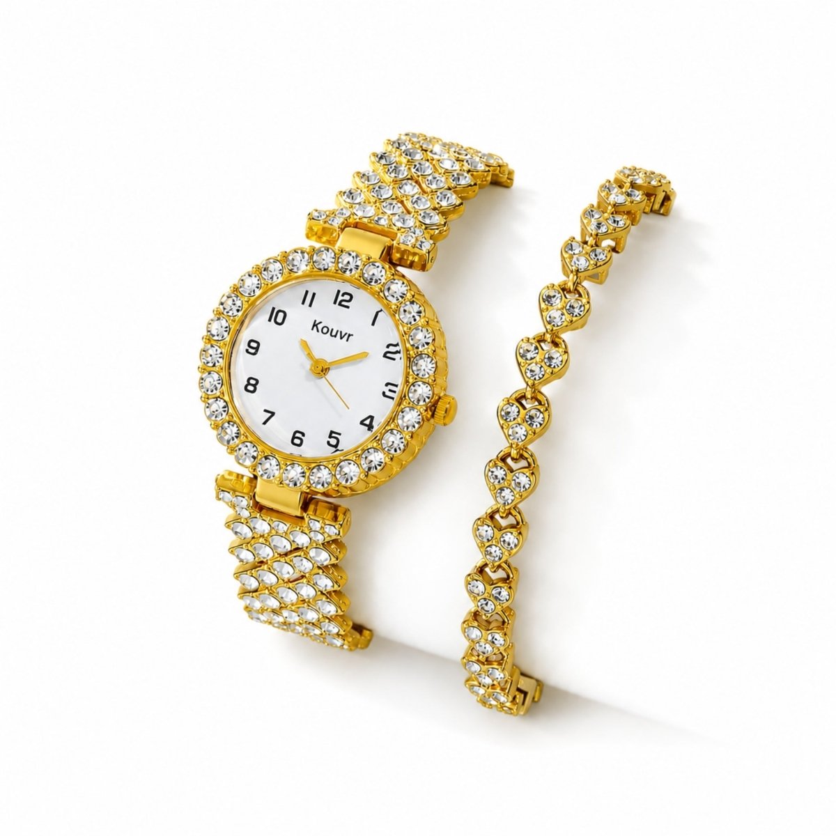 Top down view of the Kouvr women's luxury gold watch with crystal halo and matching iced out heart bracelet on a white background.
