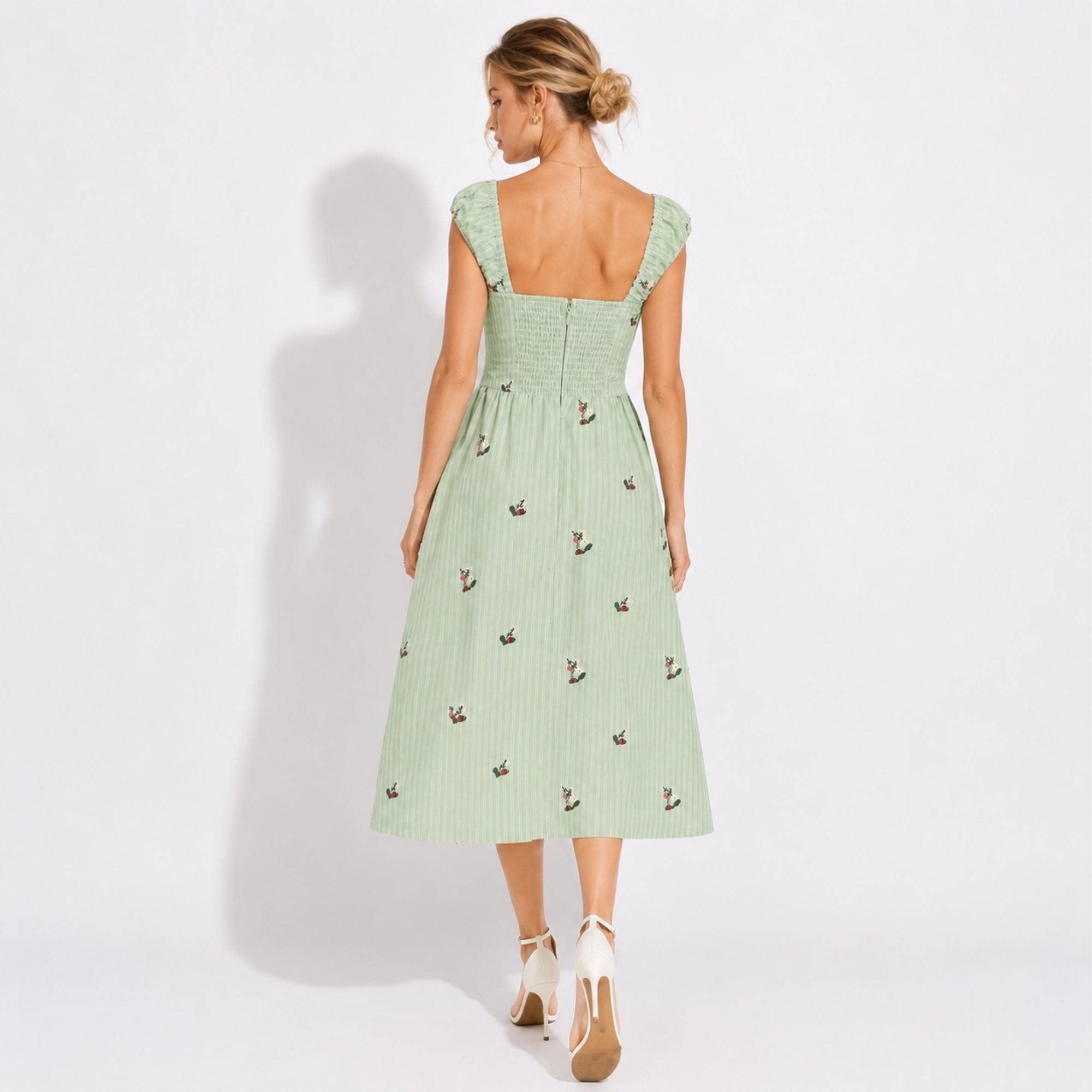 Back view of green cottagecore sundress featuring smocked back detail and concealed zipper