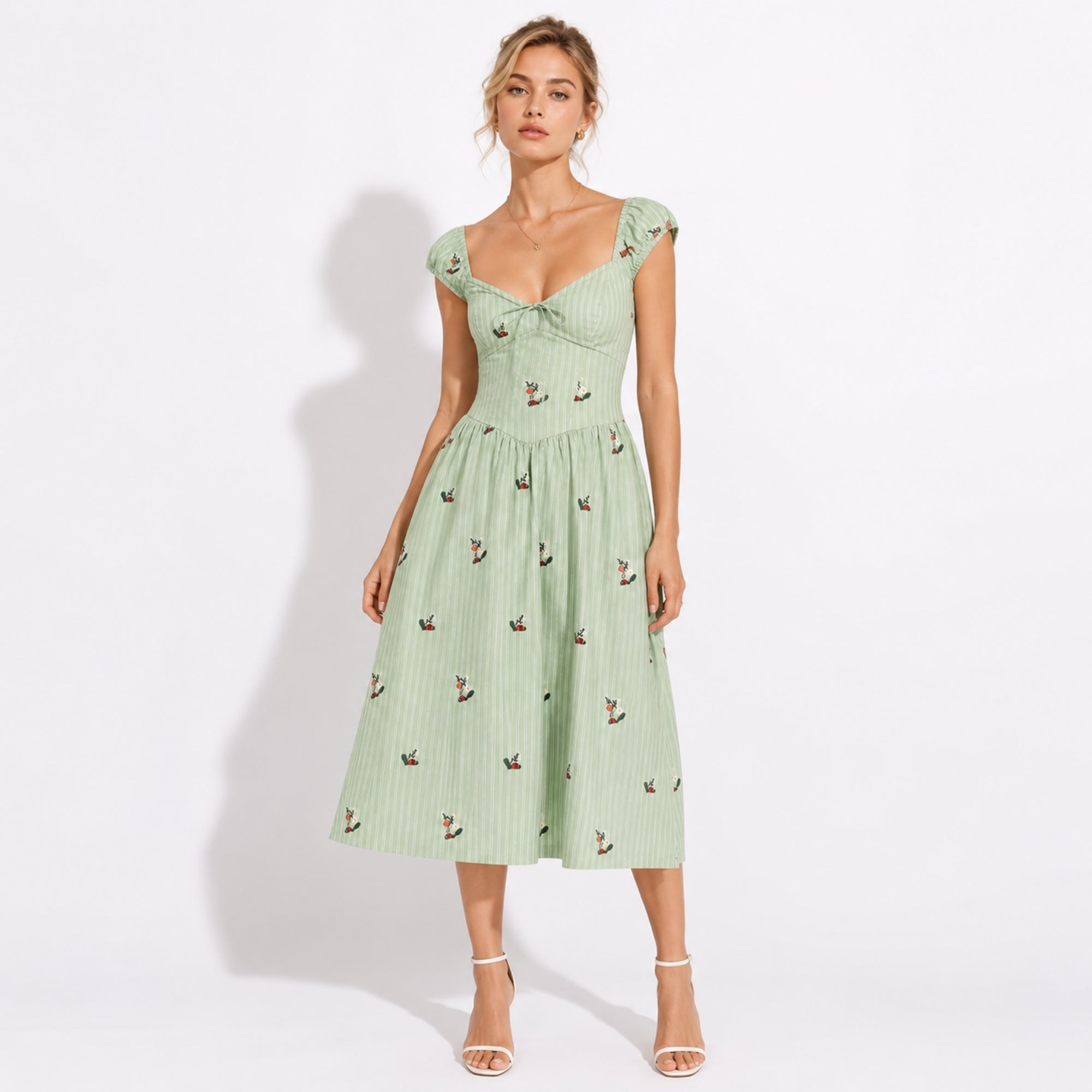 Woman modeling green pinstripe midi dress with floral embroidery and sweetheart corset bodice