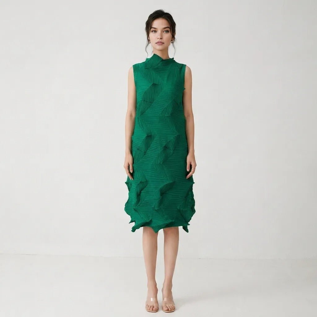 Brunette woman wearing an emerald green architectural 3D pleated sleeveless midi dress facing forward on a minimalist white background.