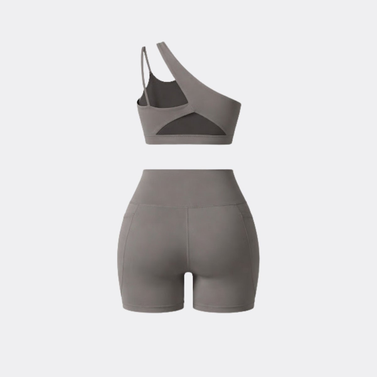 Flat lay back view showing the strappy cutout back of the Kouvr grey one shoulder activewear matching set.