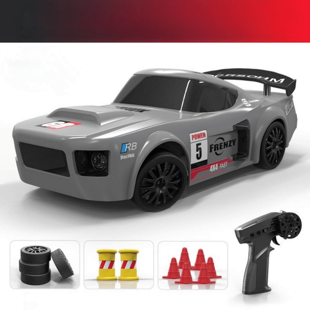 Grey widebody drift RC car with racing decals and the number 5, shown with its remote, spare tires, cones, and drums.