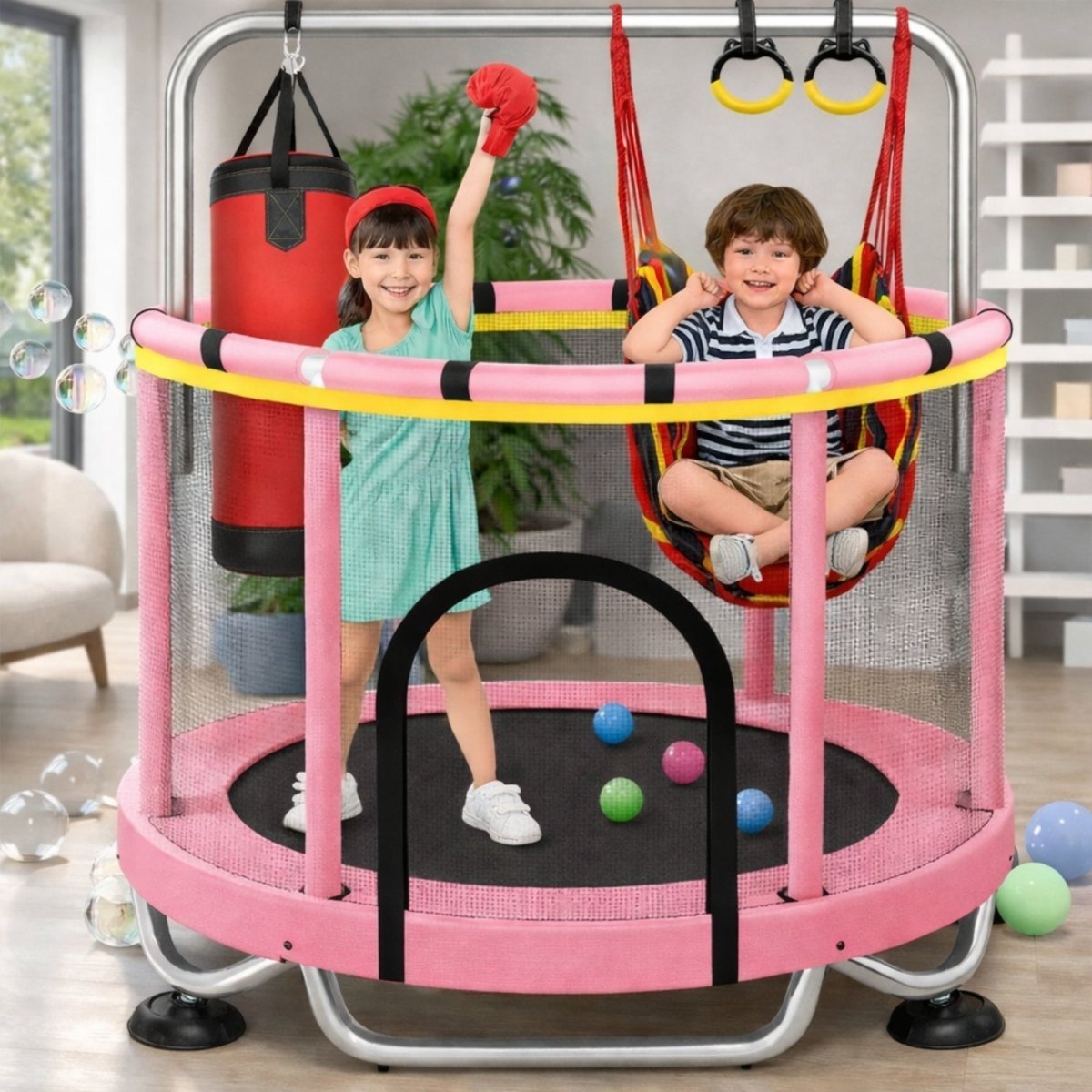 Girl in a green dress and red boxing glove standing on a pink Kouvr 4-in-1 indoor trampoline next to a punching bag, with a boy sitting in the swing.