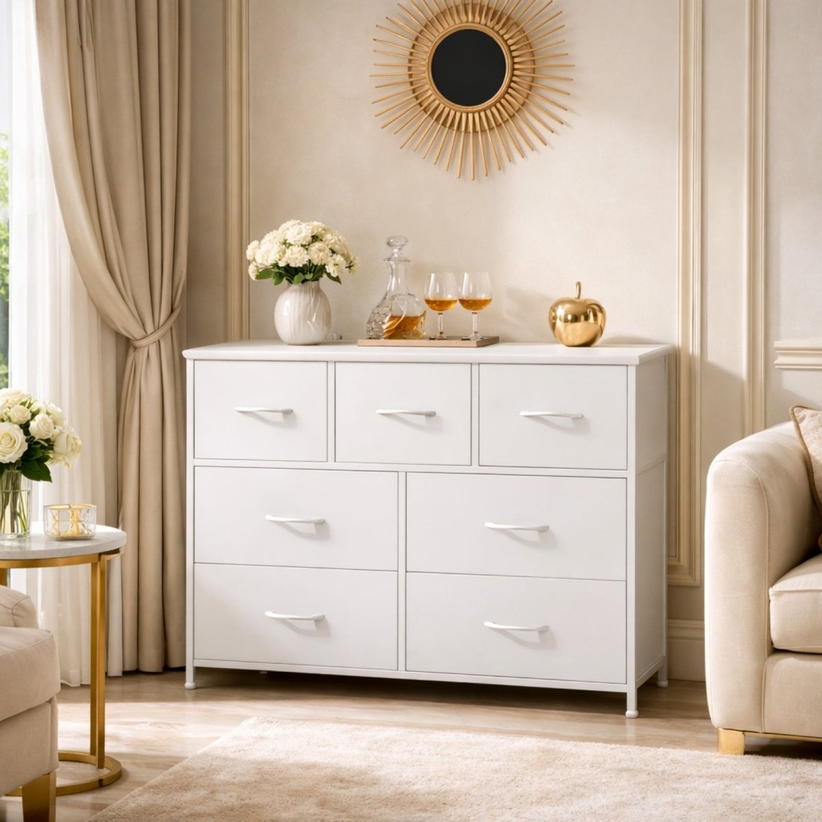 The Kouvr 7-drawer white and gold dresser styled in a bright living room with a sunburst mirror and a decanter set on top.