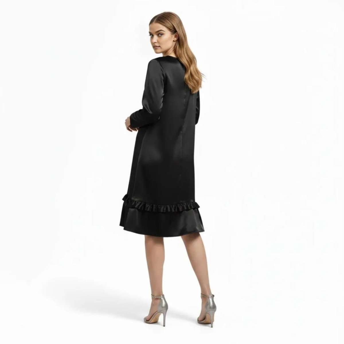 Back view of the Kouvr Adalee minimalist little black dress showing its fluid drape and long sleeves.