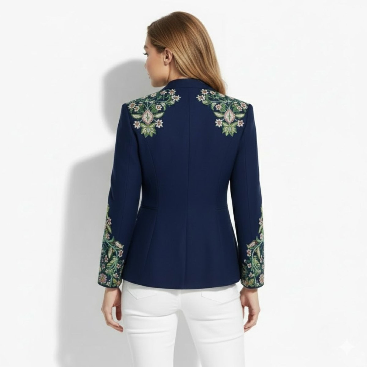 Back view of the Kouvr Aiko green band jacket, showcasing the symmetrical floral embroidery on the shoulders and structured seaming