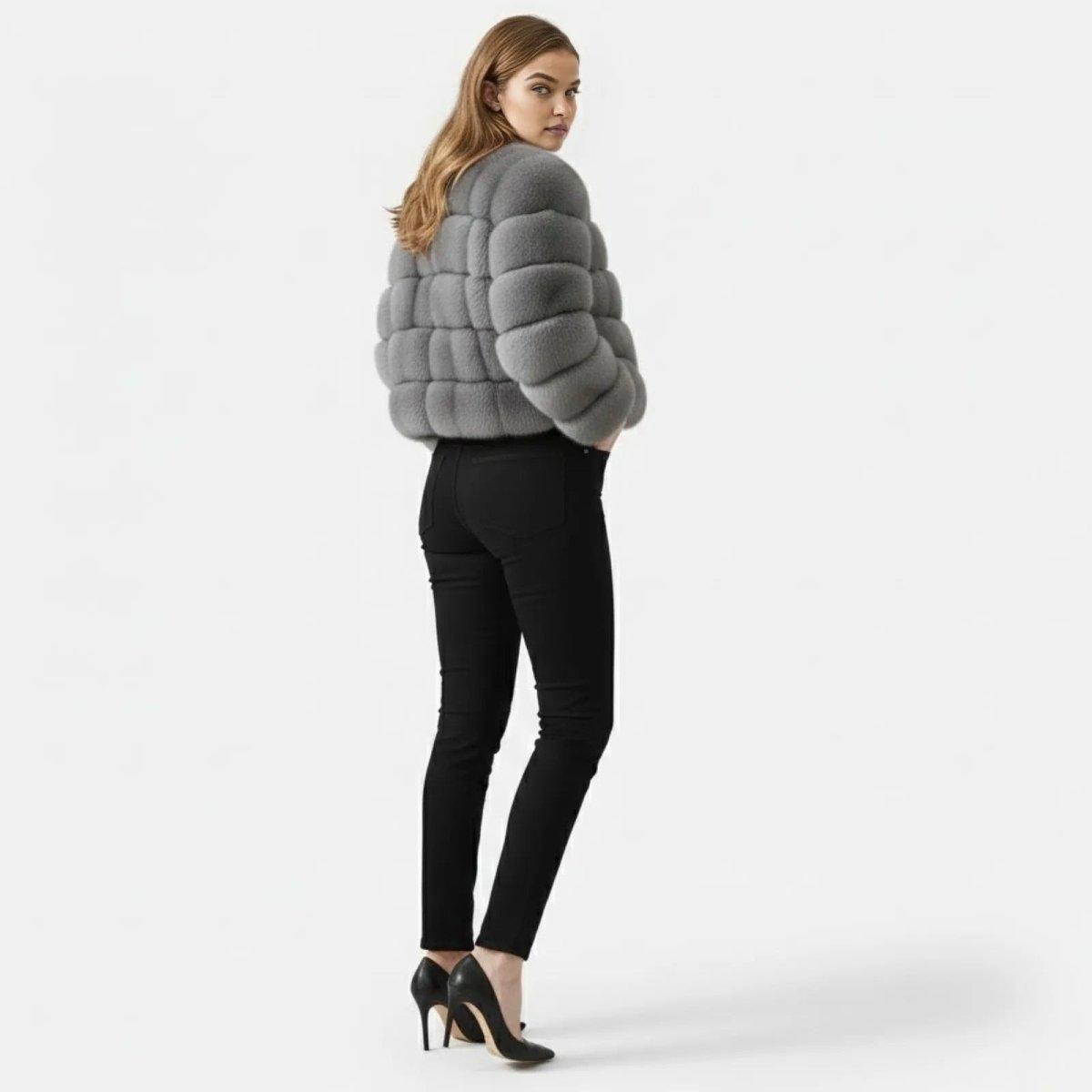 Back view of the Alexia grey faux fur jacket showing the horizontal panel detailing and collarless design.