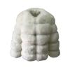 Front view product shot of the white paneled luxury vegan fur coat on a plain background, highlighting the collarless design and tiered texture.