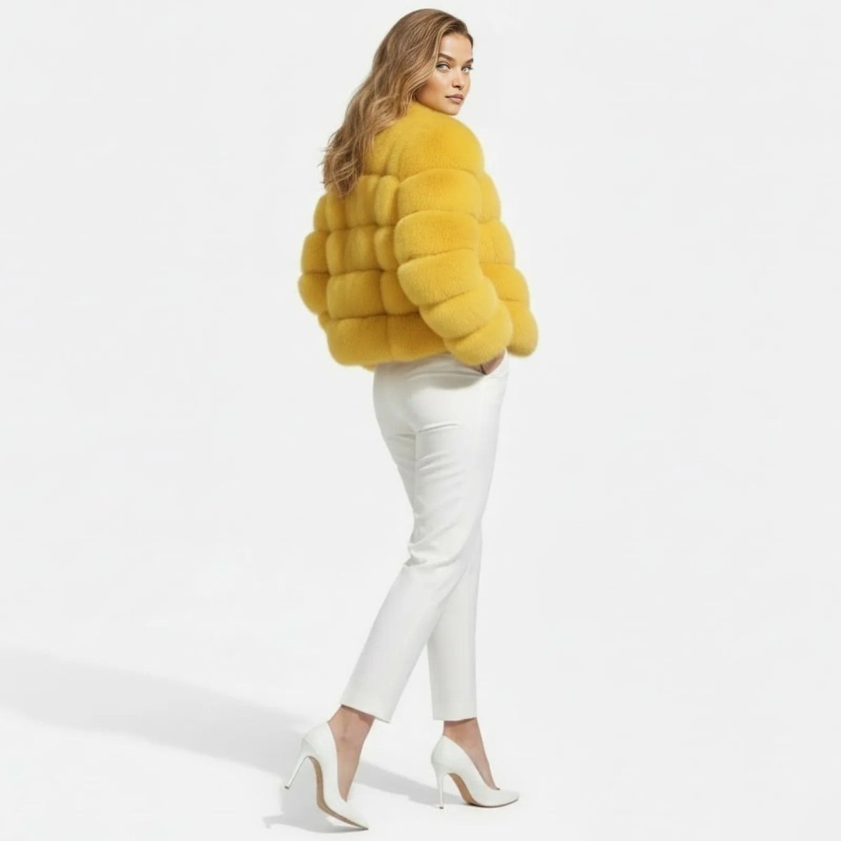 Model from a three-quarter back view looking over her shoulder, wearing the Kouvr Fashion yellow faux fur coat.