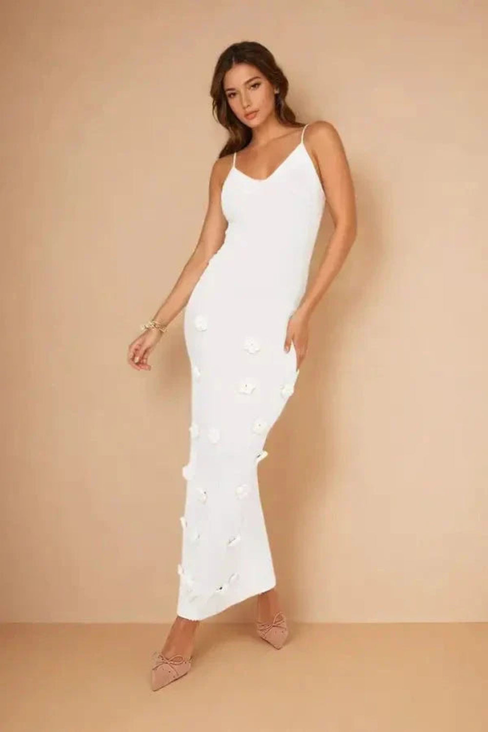 Model wearing the Kouvr Alexie backless white maxi dress with 3D floral details