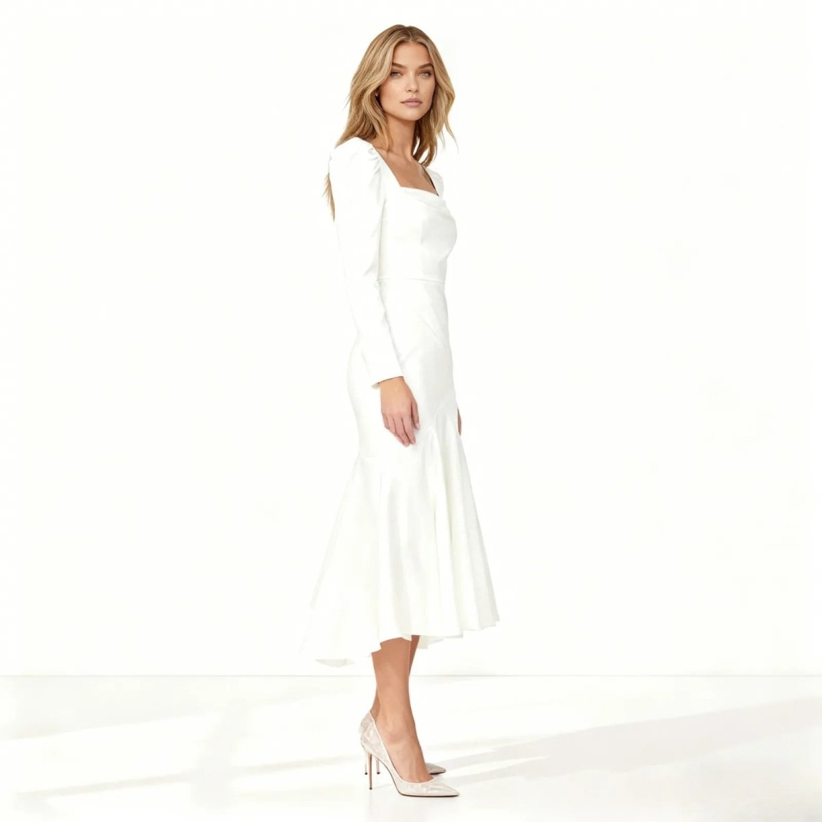 A detailed view of the Alyssa white formal midi dress, with the model looking down to showcase the square cowl neckline and draped satin fabric.