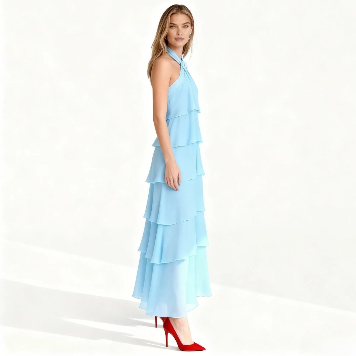 Woman wearing a light blue Kouvr tiered dress on a white background