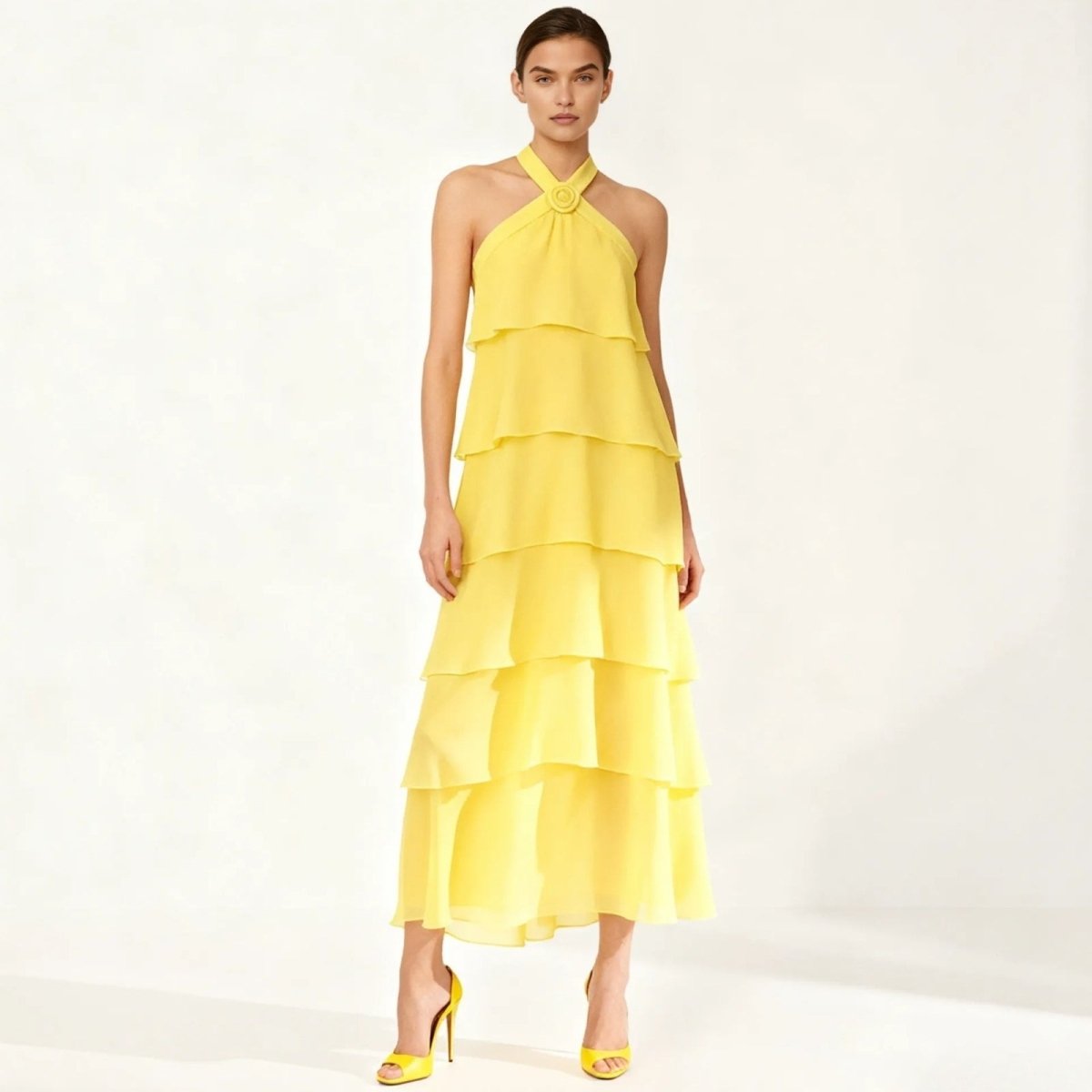 Yellow Kouvr tiered dress worn by a model on a white background