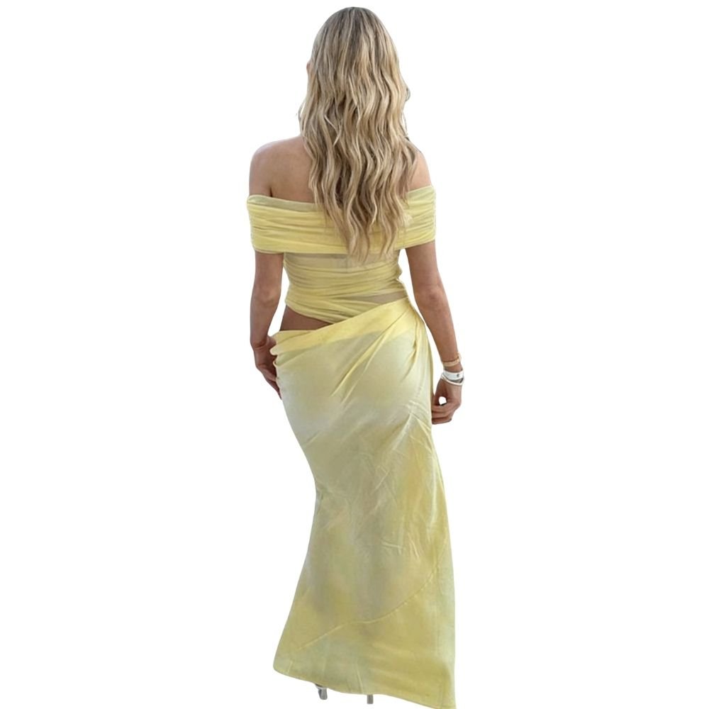 Model wearing the Kouvr Anita Gown in Lemon Chiffon, a yellow off-the-shoulder maxi dress with a side waist cutout