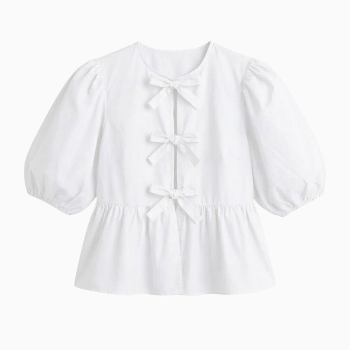 Flat lay image of the white Kouvr Anne peplum blouse showcasing the three front bows and puff sleeve details.
