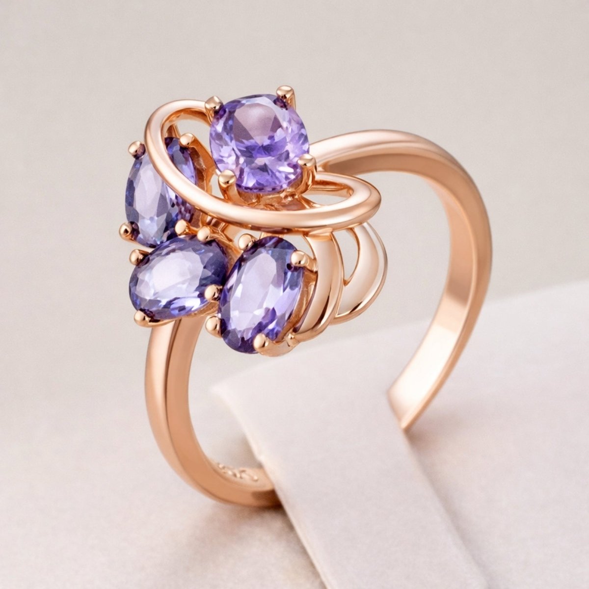 Angled view of the Kouvr Annika cluster ring on a display stand, showing the dimension and craftsmanship of the rose gold setting.