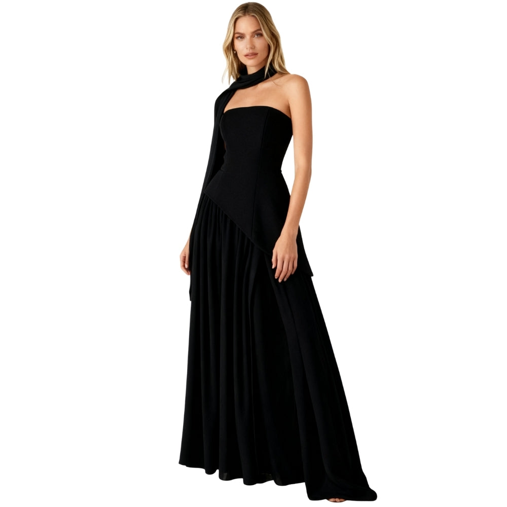 Woman wearing a black Kouvr halter neck gown on a white background