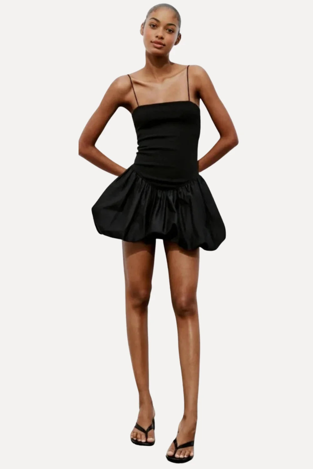 Model wearing the Kouvr Aubrey black mini dress with a voluminous bubble skirt and square neckline