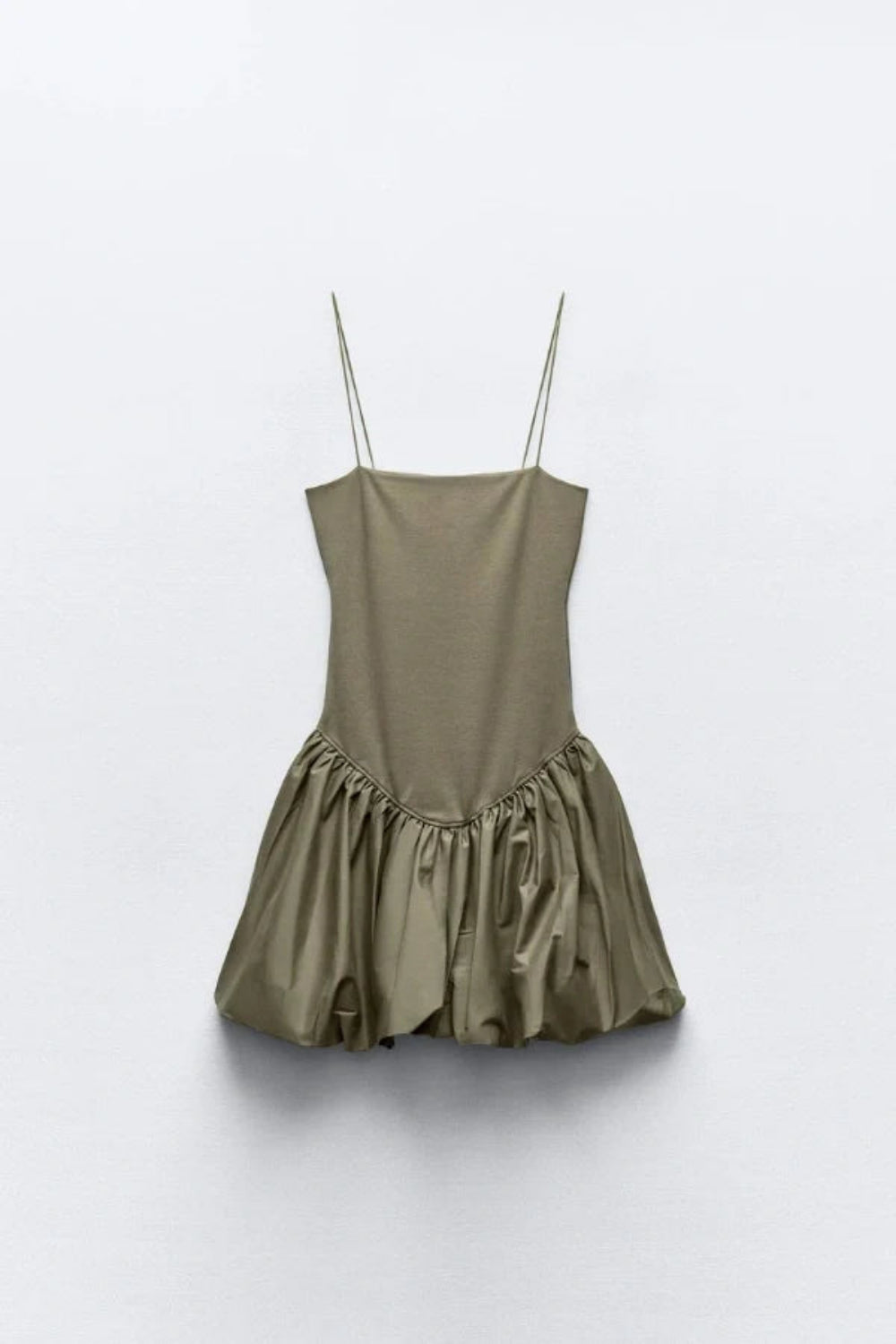Model from the back wearing the Kouvr Aubrey olive green drop waist mini dress with a sculptural bubble skirt