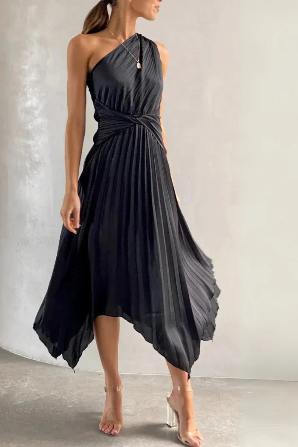 Model wearing the Kouvr Audrine one shoulder silk gown in black, showcasing its draped, asymmetrical design